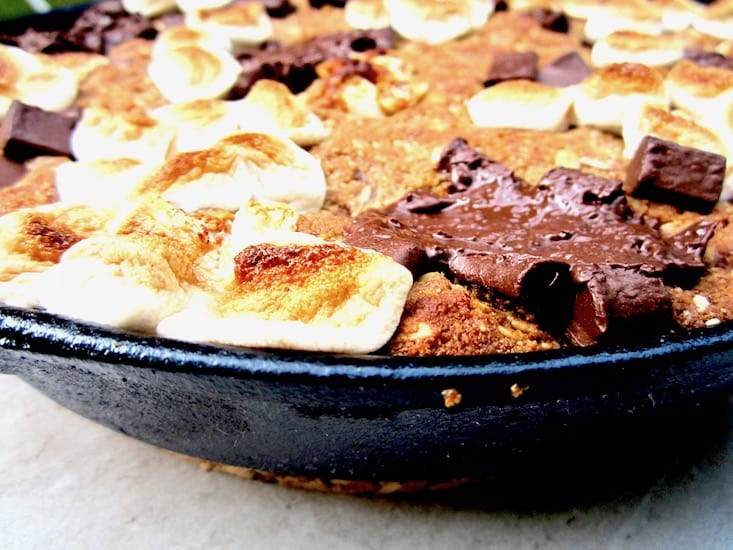 S’mores Oatmeal Cookie Skillet Cake recipe - This vegan and gluten free thick cookie cake is a hybrid between oatmeal bars and cookies, with chocolate chunks, marshmallows, oats, coconut flour and flavorful hints of cinnamon, nutmeg and ginger. A new spin on an old classic, perfect for summer or anytime of year! | veganchickpea.com
