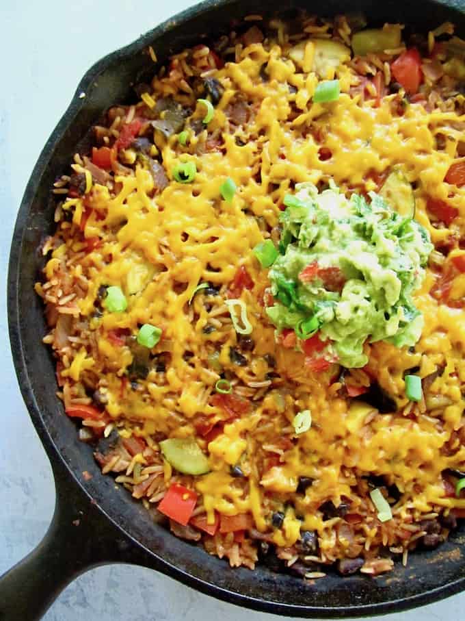 This Easy One Pan Meal: Vegan Mexican Rice Skillet (gluten free!) is a great weeknight dinner side or main meal. Simply toss rice, black beans, diced tomatoes, Simply Organic Simmer Sauce and some veggies in a skillet and let simmer. Minimal chopping required! | veganchickpea.com