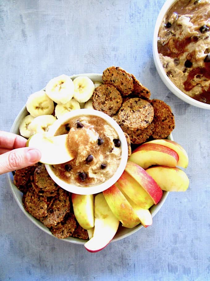 This chocolate chip dip dessert hummus is a sweet spread made from chickpeas and flavored with almond butter, maple syrup and mini chocolate chips - all topped with an easy caramel sauce. Filled with protein and fiber, this healthier dessert is also vegan, gluten free and refined sugar free! 
