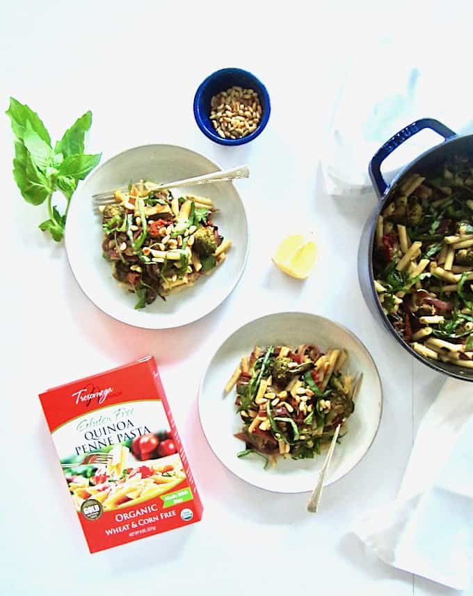 An easy, healthy, vegan and gluten free Italian penne pasta recipe featuring a garlic and balsamic roasted vegetable medley of broccoli, mushrooms, red onion, zucchini and chopped almonds for crunch. Toss it all together with sun-dried tomatoes, arugula, basil and pine nuts and you have a vibrant and colorful dish bursting with fresh flavor.