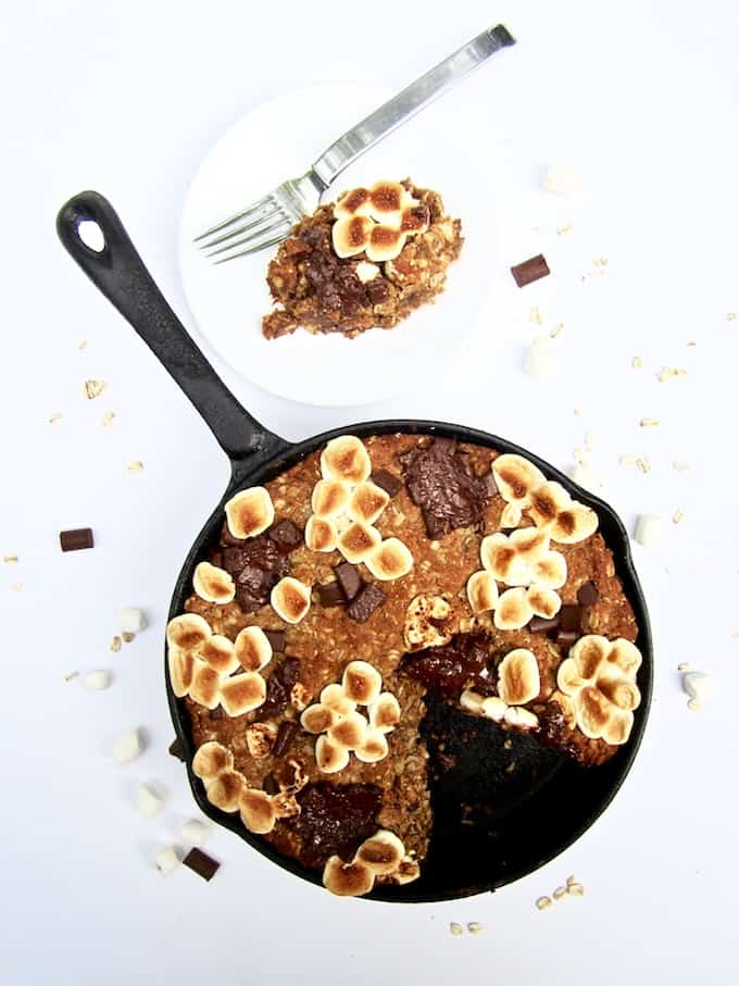S’mores Oatmeal Cookie Skillet Cake recipe - This vegan and gluten free thick cookie cake is a hybrid between oatmeal bars and cookies, with chocolate chunks, marshmallows, oats, coconut flour and flavorful hints of cinnamon, nutmeg and ginger. A new spin on an old classic, perfect for summer or anytime of year! | veganchickpea.com