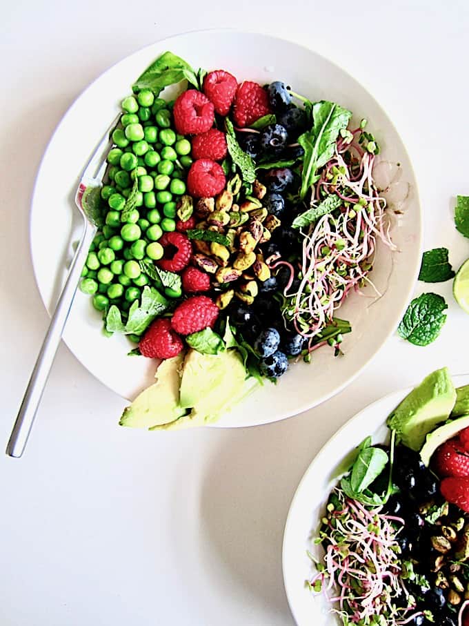 Berry, Pea & Pistachio Summer Salad + Sugar Free Mojito Dressing Recipe - Enjoy fresh seasonal produce with this colorful salad showcasing fresh raspberries, blueberries, peas and toasted pistachios over crisp greens, topped with an easy, zesty sugar free lime + mint mojito vinaigrette dressing! | Vegan, Gluten Free, Paleo | veganchickpea.com