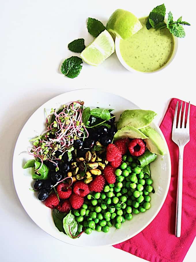 Berry, Pea & Pistachio Summer Salad + Sugar Free Mojito Dressing Recipe - Enjoy fresh seasonal produce with this colorful salad showcasing fresh raspberries, blueberries, peas and toasted pistachios over crisp greens, topped with an easy, zesty sugar free lime + mint mojito vinaigrette dressing! | Vegan, Gluten Free, Paleo | veganchickpea.com