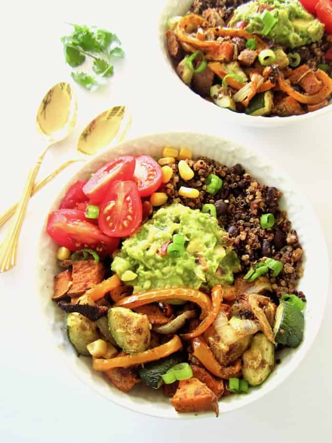 These vegan Southwest Veggie Burrito Bowls are an easy meal your whole family will enjoy! The quinoa and black bean base pack each plate with 13 grams of plant based protein. Top the bowls with homemade guacamole for super fresh flavor. Great for dinner, leftovers and as lunch the next day!