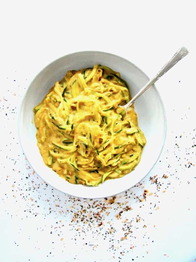 This super healthy yet satisfying and craveable 'mac & cheese' recipe mimics the flavor of the classic dish with a superbly easy, 5-ingredient vegan cheese sauce made out of sweet potatoes. Served over zucchini noodles (zoodles), this gluten free, flavor packed and  veggie-filled dish is also low carb, oil-free and comes together in 30 minutes. You won't believe it's cheese-less!