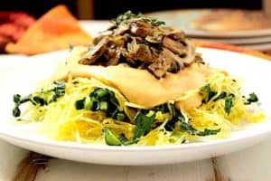 Roasted spaghetti squash is the perfect healthy, low carb, satisfying meal for Fall. Pair it with a creamy vegan cashew cheese sauce, superfood stars mushrooms and kale or spinach, and you've got a vegan, gluten free and paleo meal that you'll want to enjoy again and again!