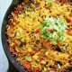 This Easy One Pan Meal: Vegan Mexican Rice Skillet (gluten free!) is a great weeknight dinner side or main meal. Simply toss rice, black beans, diced tomatoes, Simply Organic Simmer Sauce and some veggies in a skillet and let simmer. Minimal chopping required! | veganchickpea.com